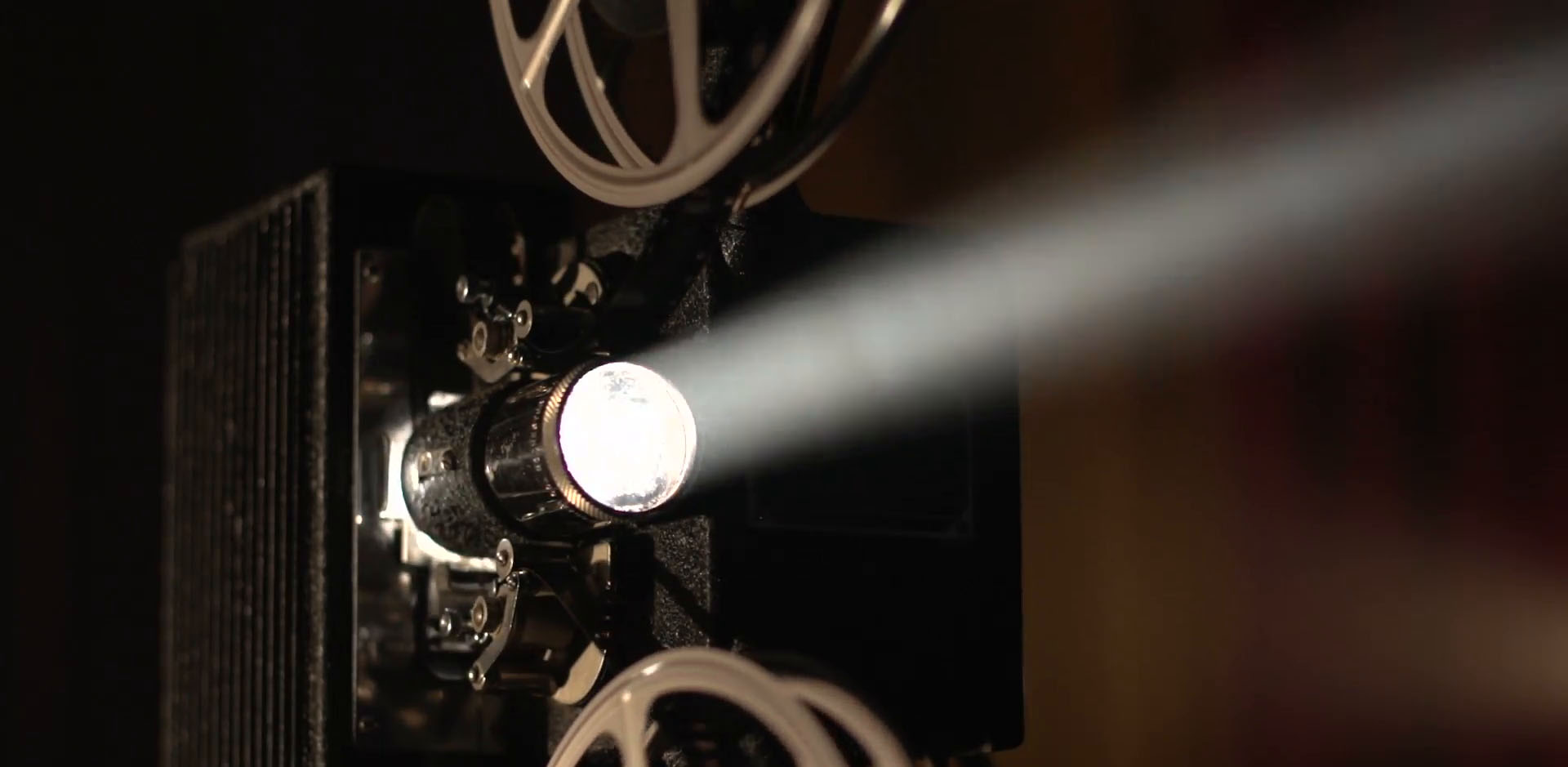 Vintage film projector casting a beam of light